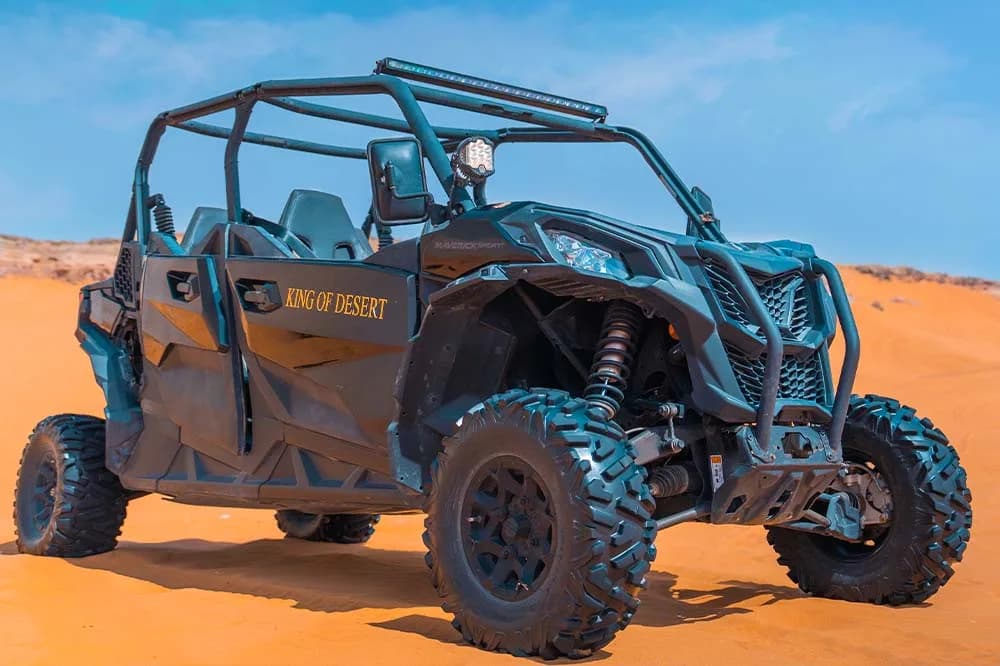 Can-Am Maverick Sport 4-seat dune buggy in the Dubai desert at golden hour