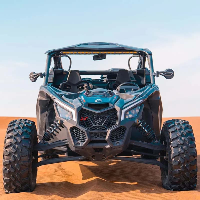 Can-Am X3 Turbo 2-seat dune buggy racing across Dubai desert dunes — photo 1