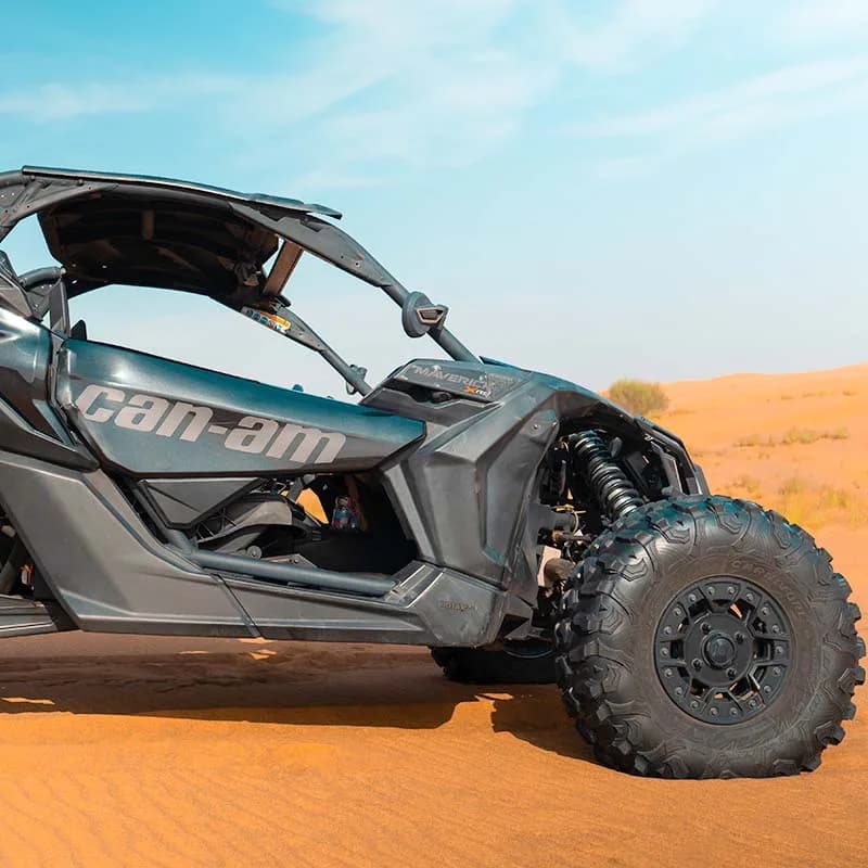 Can-Am X3 Turbo 2-seat dune buggy racing across Dubai desert dunes — photo 2