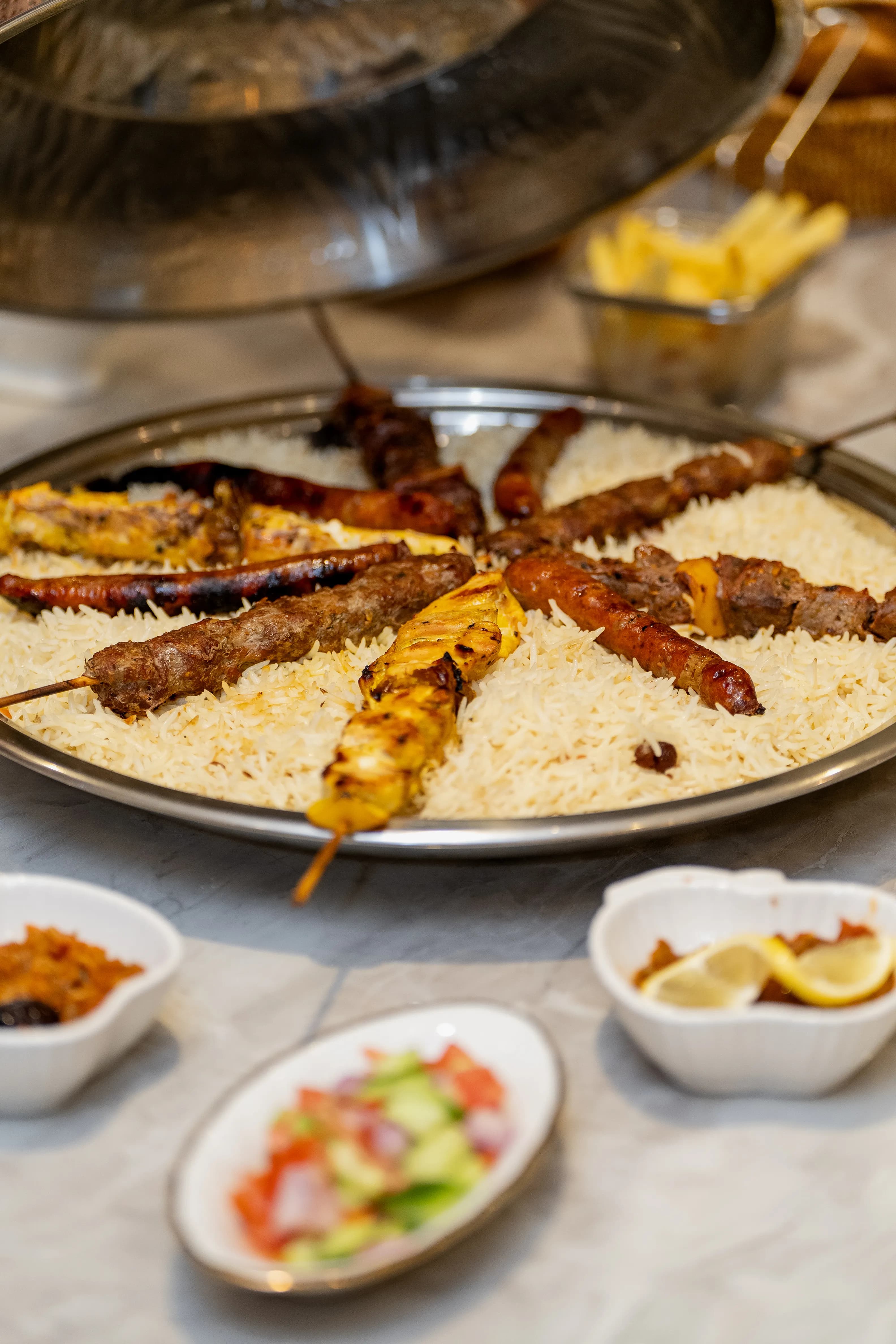 Mixed grill platter with rice and salads served at the camp