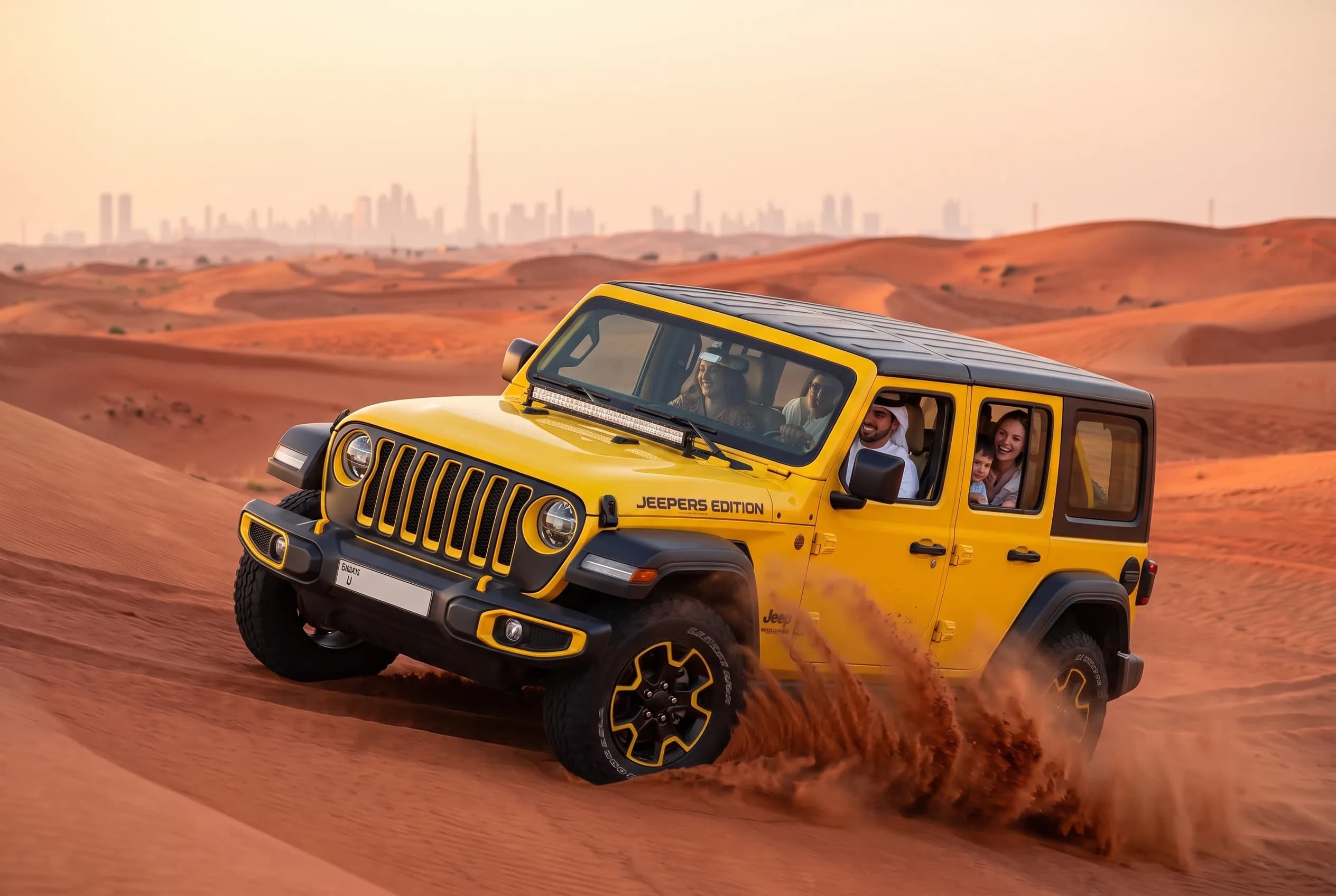 Yellow Jeep Wrangler crossing red desert dunes with the Dubai skyline behind