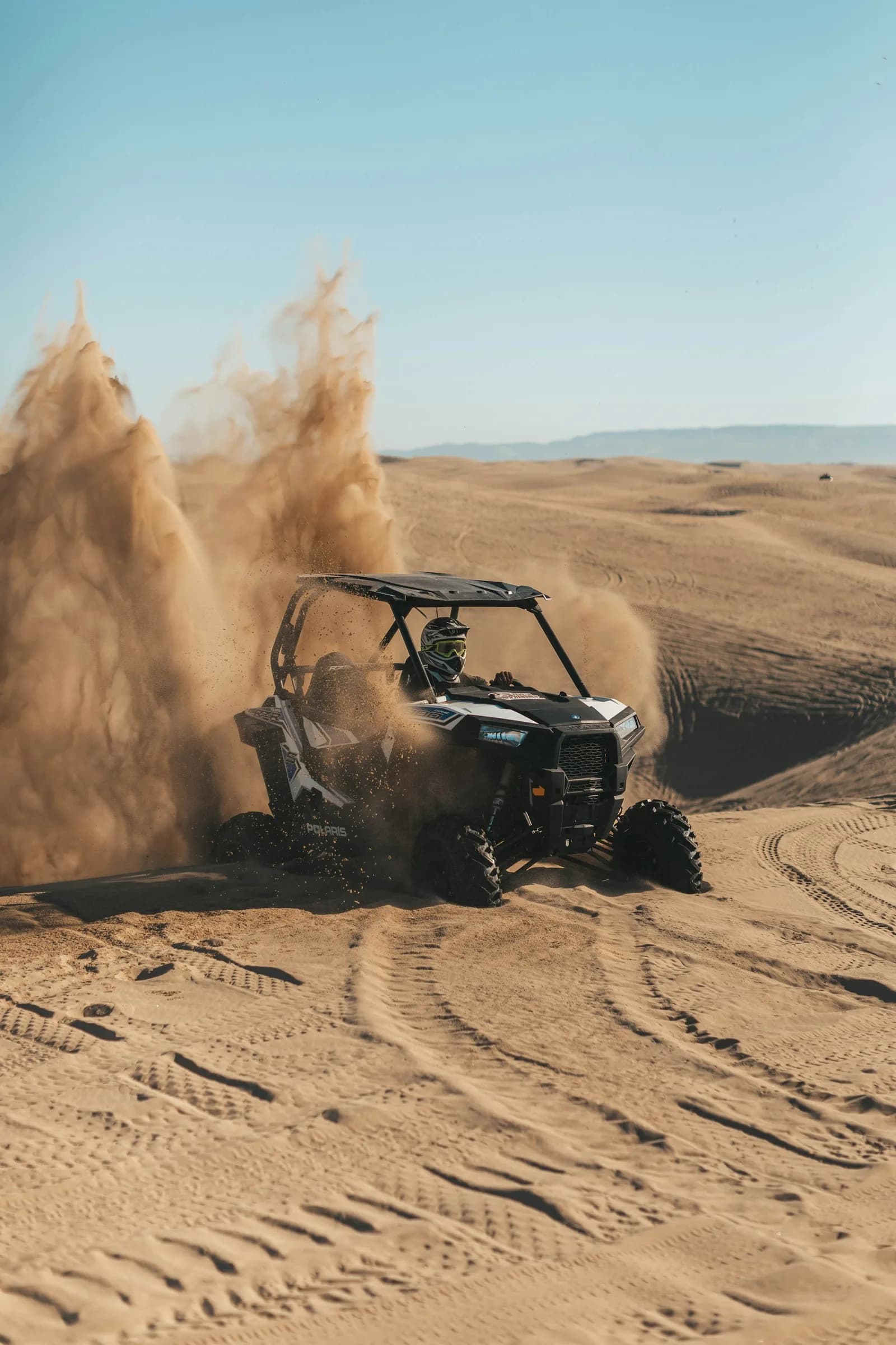 Kids dune buggy ride on a safe sandy track in the Dubai desert