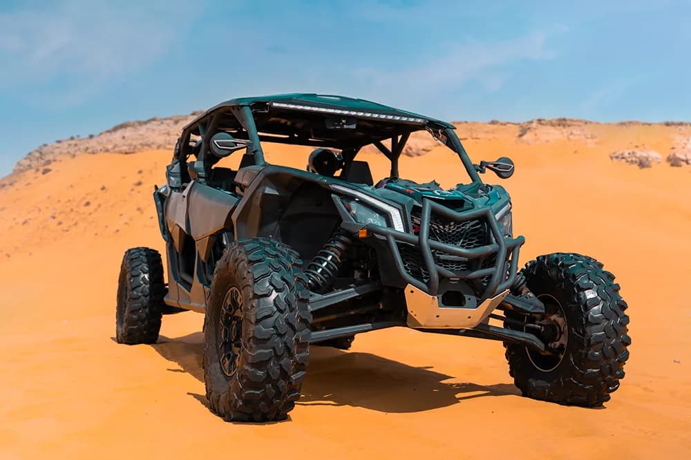 Can-Am X3 Turbo 4-seat dune buggy on the red dunes of the Dubai desert