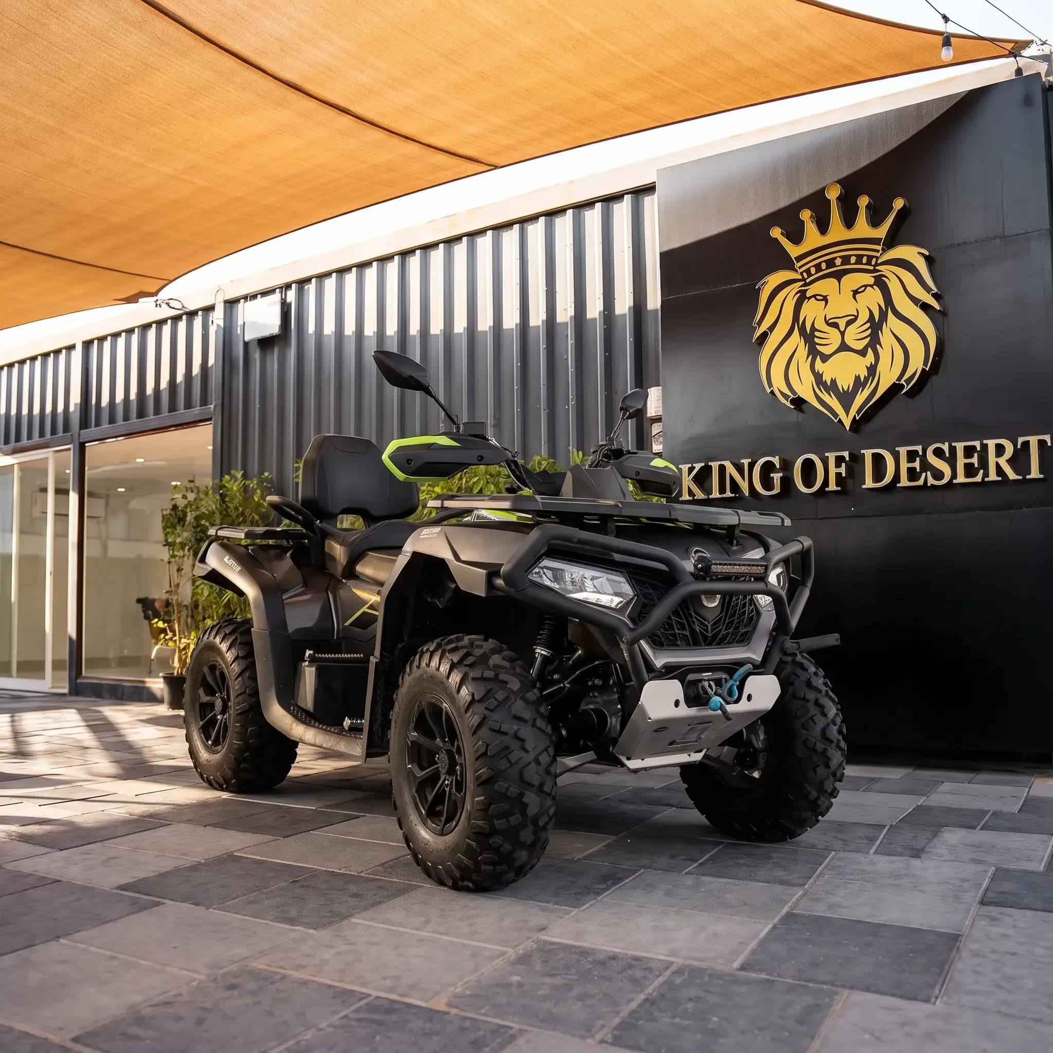 Black CFMOTO CF625 quad bike parked in front of the King of Desert showroom, Dubai